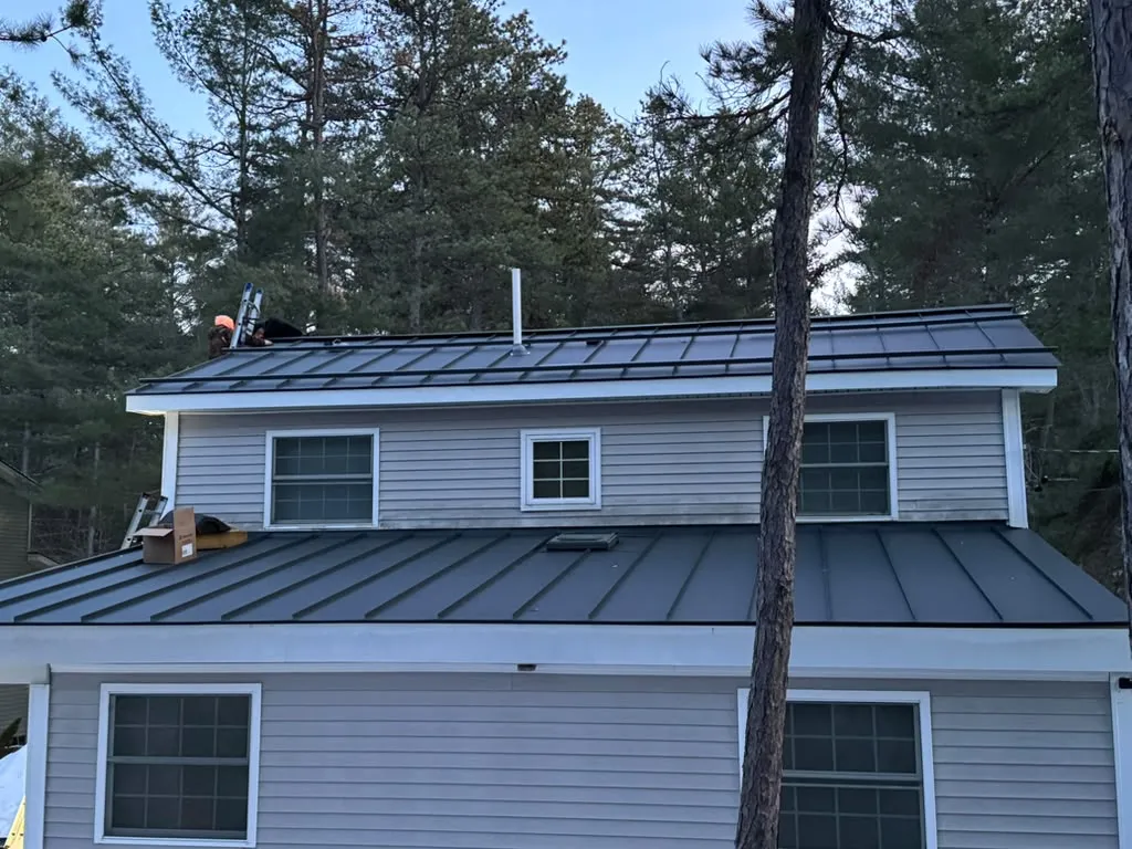 Aging asphalt shingle roof on a New England home