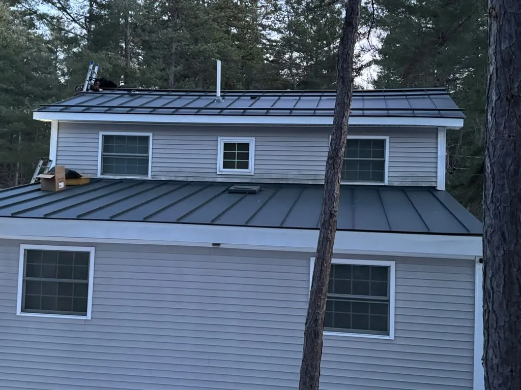 Rust and loose fasteners on a metal roof in Massachusetts
