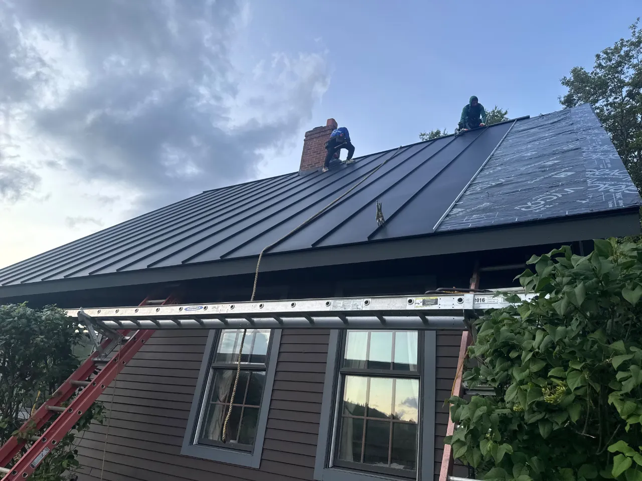 Roofing contractor in Massachusetts installing a new roof on a home