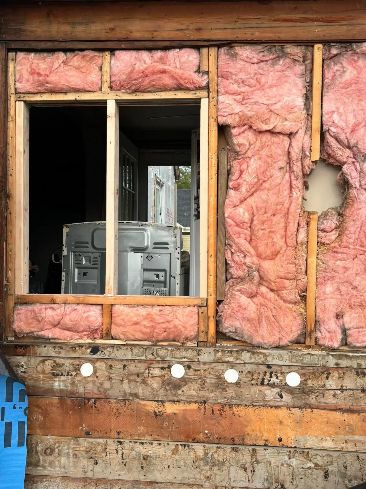 Cracked and loose siding panels on a home in Massachusetts