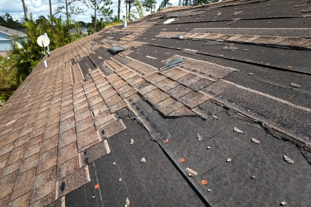 Storm damaged shingles on a roof in Massachusetts